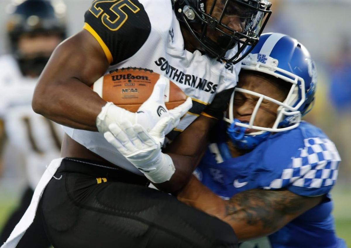 Southern Mississippi’s Ito Smith, with ball, ran for 173 yards and a touchdowns and caught five passes to help the Golden Eagles upset Kentucky 44-35 in the 2016 season opener in Lexington.