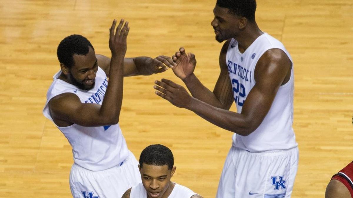 Kentucky Wildcats forward Alex Poythress (22) gave a celebratory shove to Dominique Hawkins (25) after he made a defensive play as UK defeated UL 75-73 in Rupp Arena Saturday Dec. 26, 2015 in Lexington, Ky.