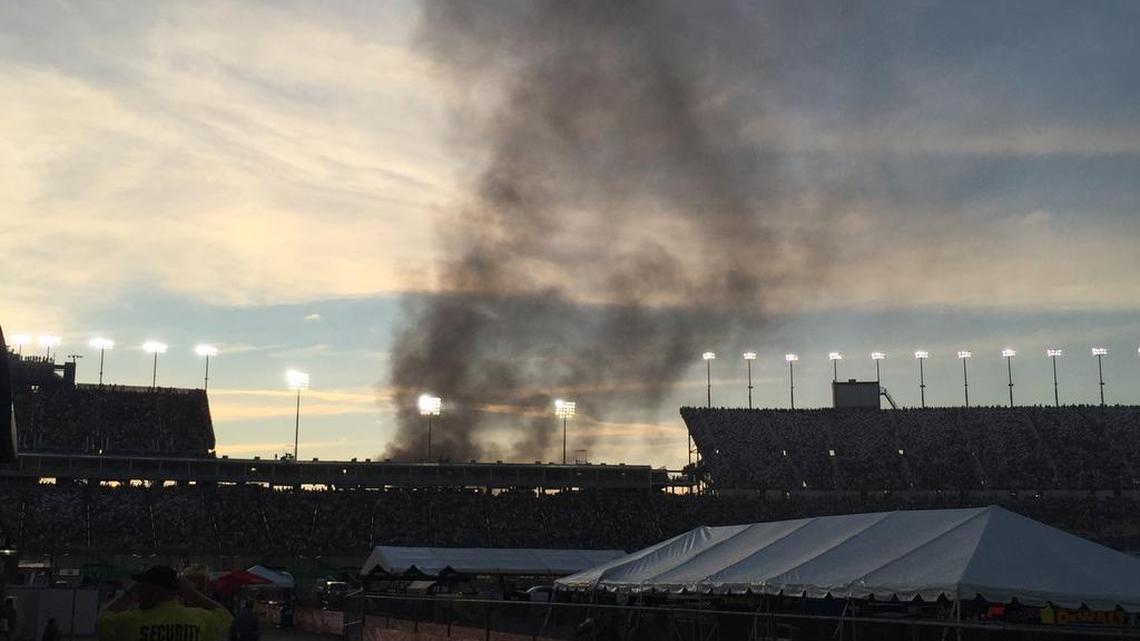 Smoke rose over the main grandstand from a vehicle fire in the platinum parking lot at Kentucky Speedway Saturday night.