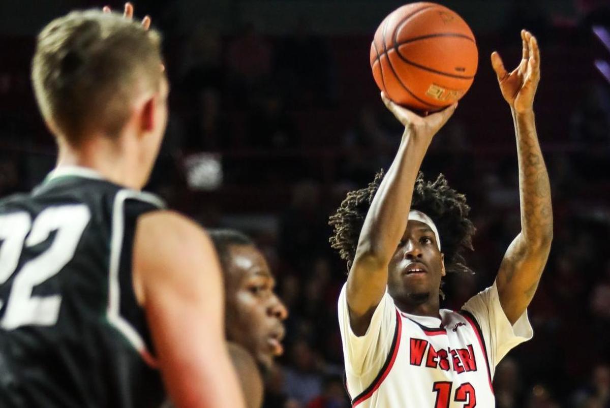 Former Paul Laurence Dunbar star Taveion Hollingsworth, shooting the ball, has emerged as an immediate starter as a Western Kentucky freshman.