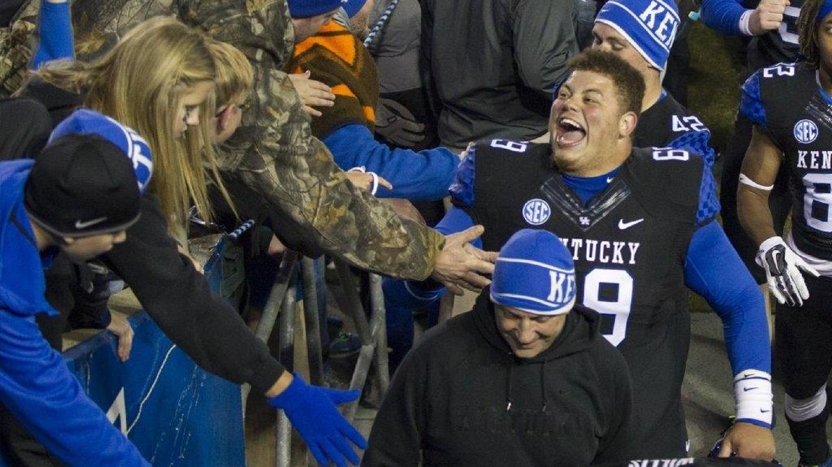 Kentucky nose guard Matt Elam celebrated with UK fans after the Wildcats rallied to beat South Carolina, 45-38, at Commonwealth Stadium in 2014.