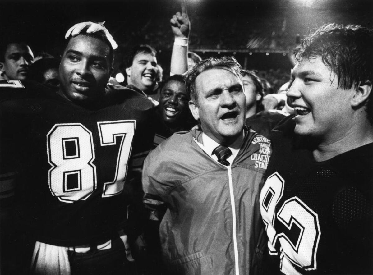 Kentucky Coach Jerry Claiborne, flanked by co-captains Oliver White, No. 87 and David Thompson, No. 92, celebrated after UK beat Wisconsin 20-19 in the 1984 Hall of Fame Bowl. Current New Mexico State head coach Doug Martin, a former Kentucky quarterback, was a graduate assistant for UK in 1984.
