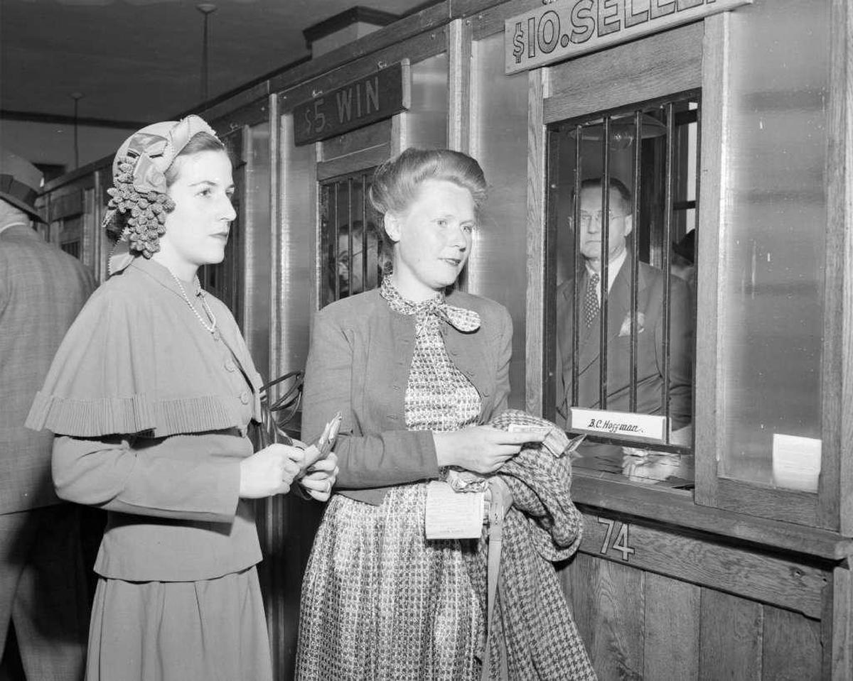 Pari-mutuel wagering on horse racing has long been part of Kentucky life - as shown by this 1949 photo of patrons preparing to place bets at Keeneland.