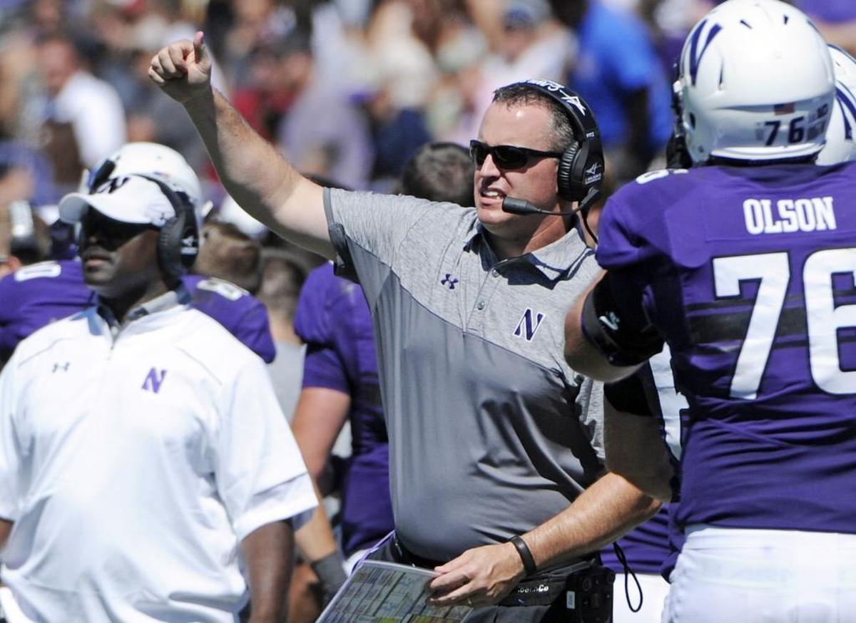 Northwestern Coach Pat Fitzgerald, center, has led the purple Wildcats (9-3) to seven-straight victories entering their Franklin American Mortgage Music City Bowl meeting with Kentucky (7-5).