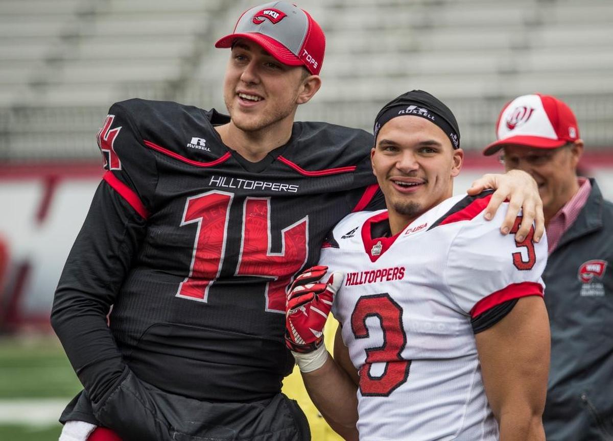 Western Kentucky quarterback Mike White hugged teammate Quinton Baker, the former Ashland star, during WKU’s spring game.