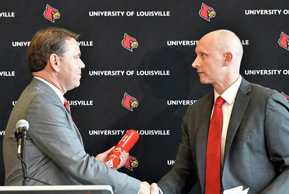 Landing a coach as accomplished as former Xavier head man Chris Mack, right, was a coup for new University of Louisville athletics director Vince Tyra, left.
