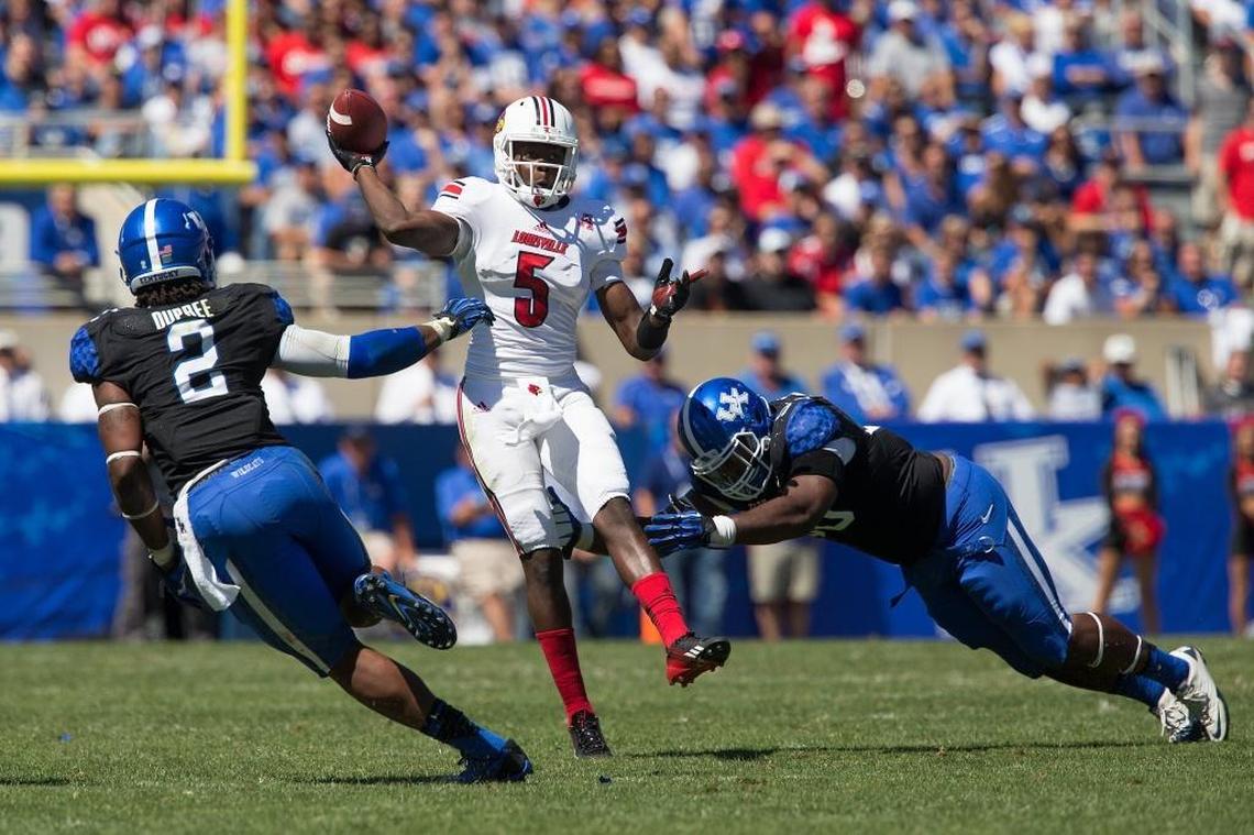 Louisville quarterback Teddy Bridgewater (5) was hurried by Kentucky defensive end Bud Dupree (2) during U of L’s 27-13 win over UK in 2013. Both Bridgewater and Dupree would go on to become NFL first-round draft picks.