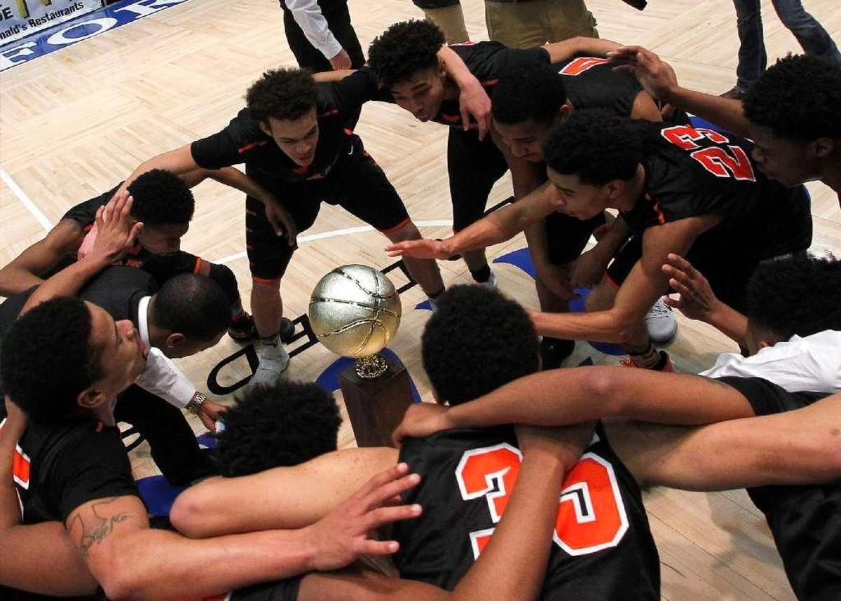 Paris High School’s boys’ basketball team celebrated after winning the 2016-17 All “A” Classic in the Frankfort Convention Center Arena.