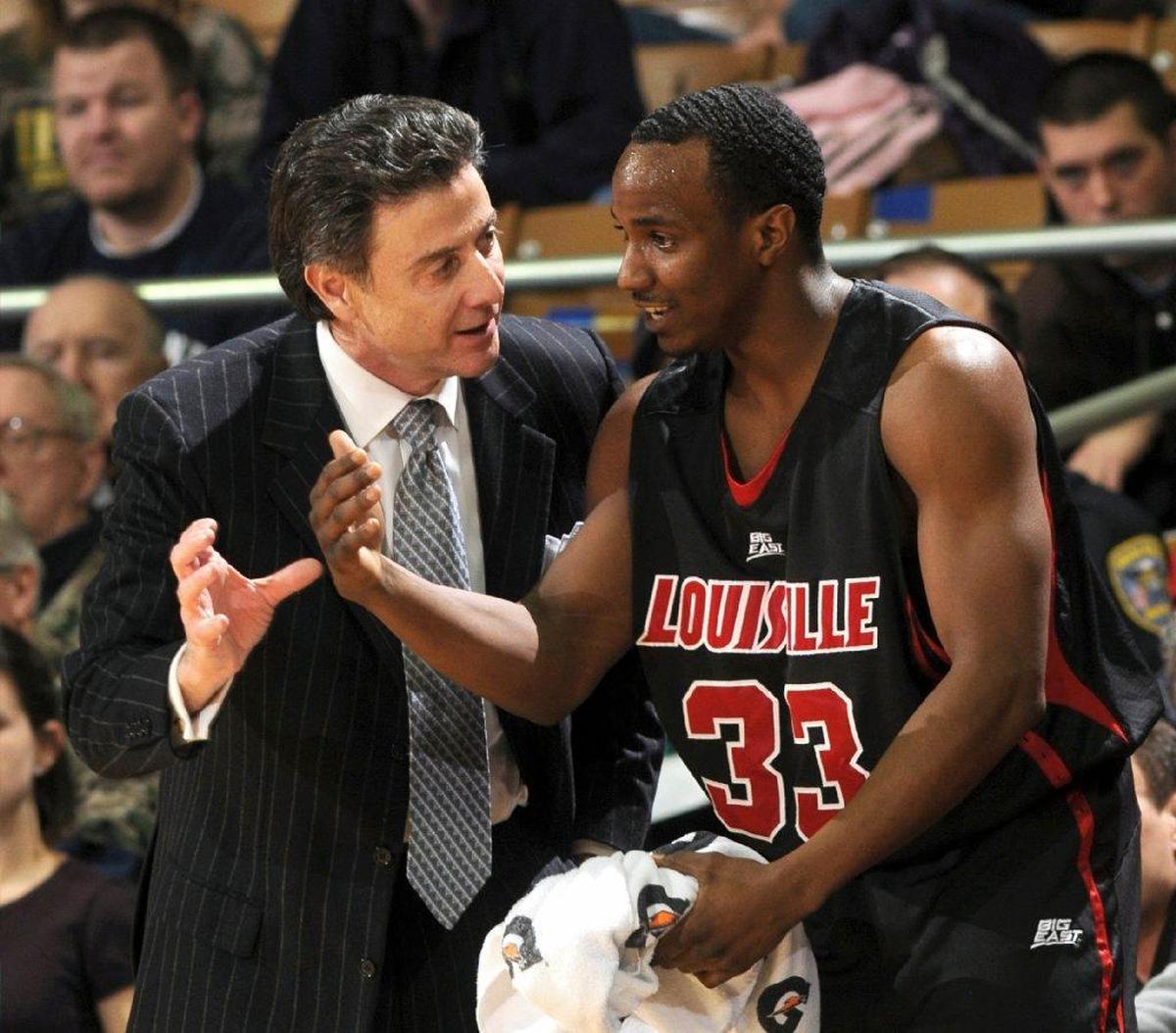 Rick Pitino, left, instucted then-Louisville guard Andre McGee during a 2009 Cardinals game at Notre Dame. Subsequently serving as U of L’s director of basketball operations, McGee is alleged to have been the organizer of strip shows and sexual encounters for basketball recruits that has landed U of L on NCAA probation.