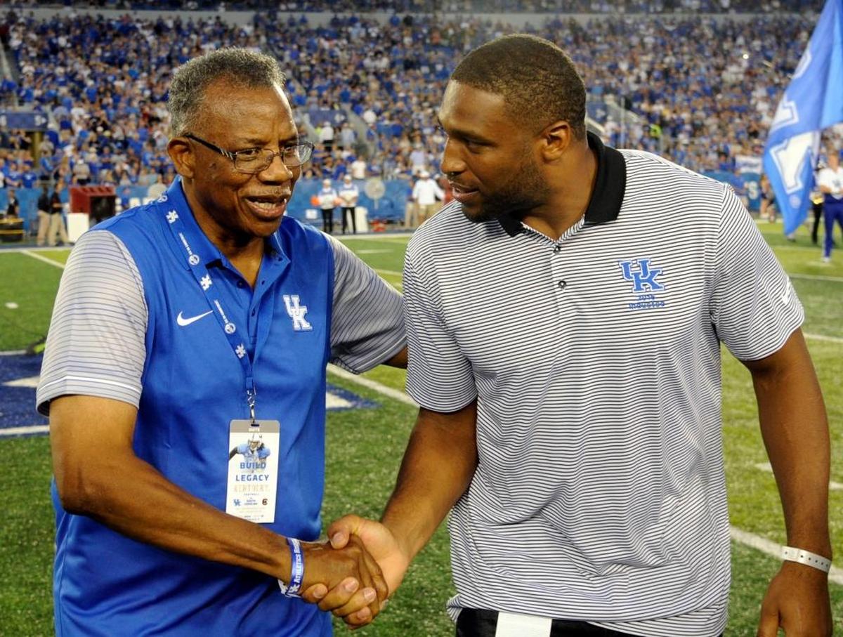 Nate Northington, left, the first black football player to play in a varsity game for Kentucky, shook hands with Tennessee Titans linebacker and ex-UK player Wesley Woodyard before the Wildcats played South Carolina in 2016.