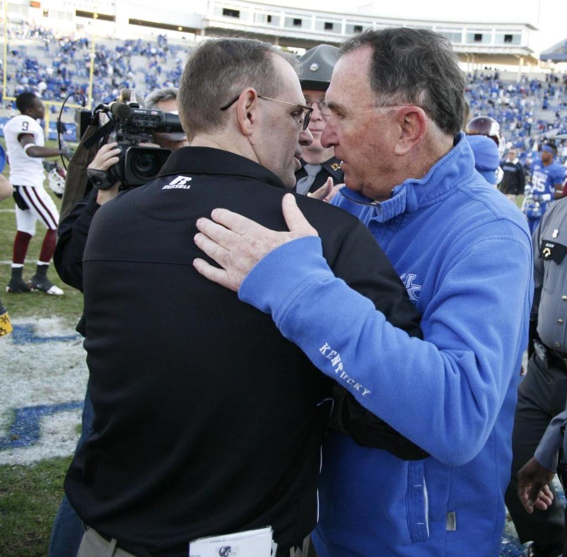Dean Hood, left, met with then-Kentucky head coach Rich Brooks after UK defeated Hood’s Eastern Kentucky Colonels 37-12 in 2009 in the venue then known as Commonwealth Stadium.