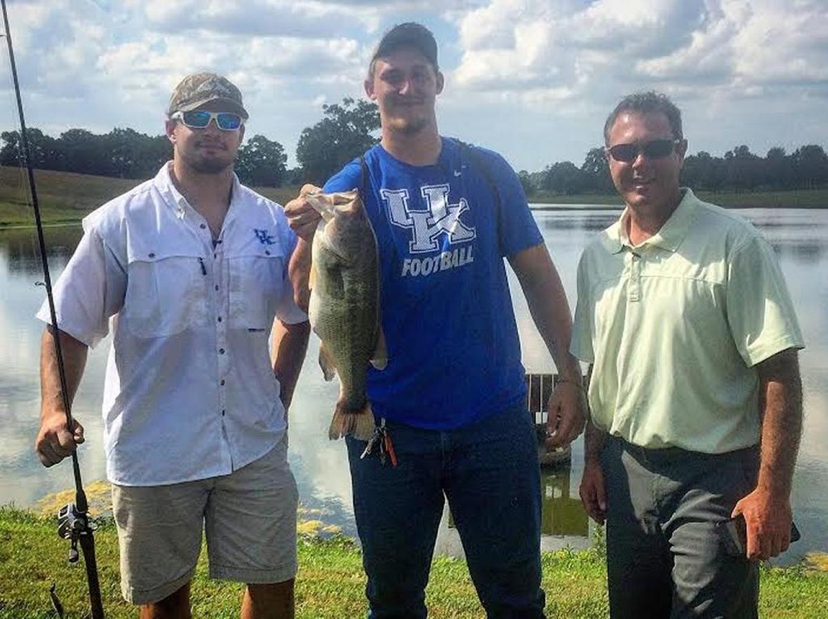 Kentucky football players Kash Daniel, left, and Landon Young, with fish, appeared with host Chad Miles on KET’s outdoors television program “Kentucky Afield” last year.