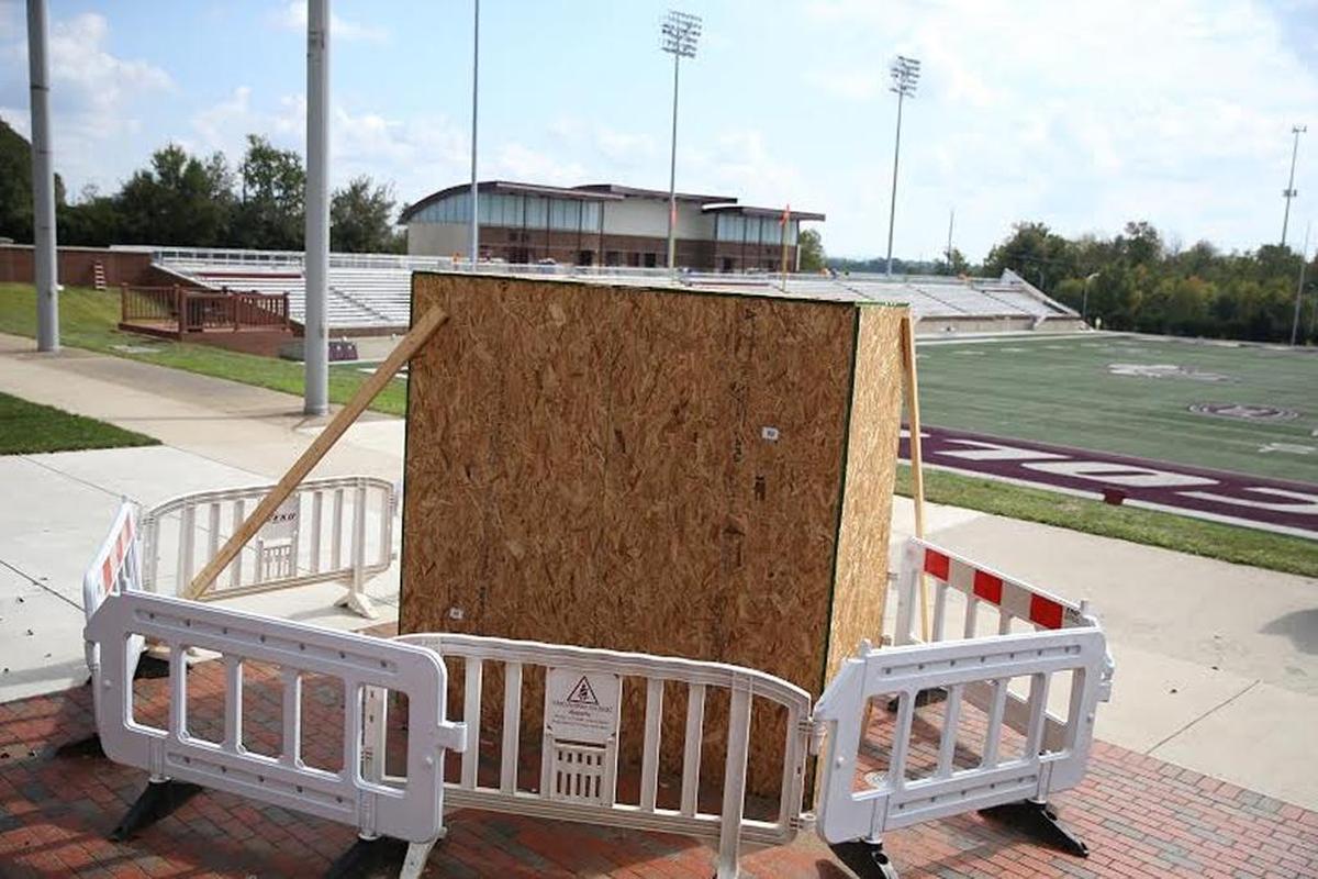 The Roy Kidd statue, done by sculptor John B. Savage Jr., in a crate waiting to be unveiled in the north end zone of the Roy Kidd Stadium.