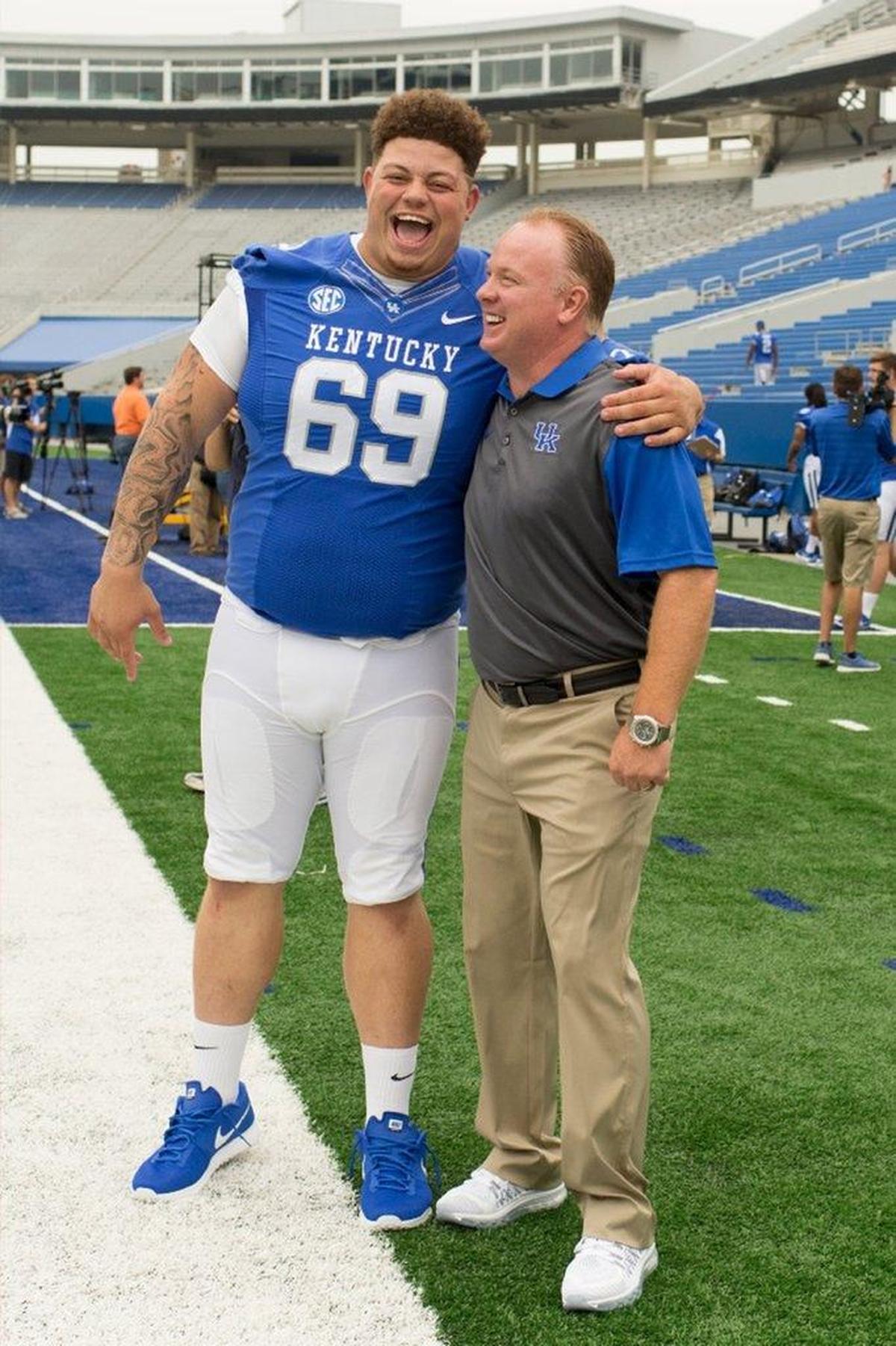 Matt Elam, No. 69, with Kentucky head coach Mark Stoops at UK’s 2015 Media Day. In June, Stoops said he met with Elam in mid-April to challenge the senior-to-be nose guard to make the off-season sacrifices necessary for him to end his college career on a high note.