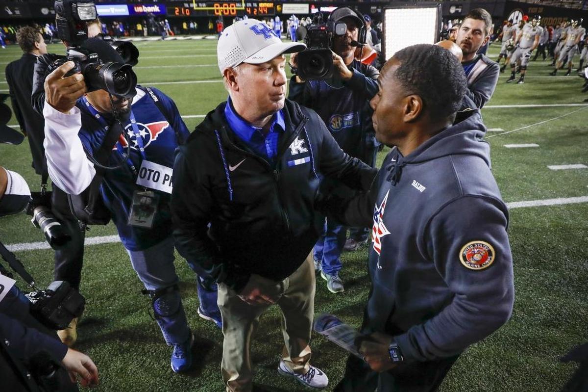 Vanderbilt Coach Derek Mason, right, is 1-5 as Commodores head man against Kentucky and its head coach, Mark Stoops, left.