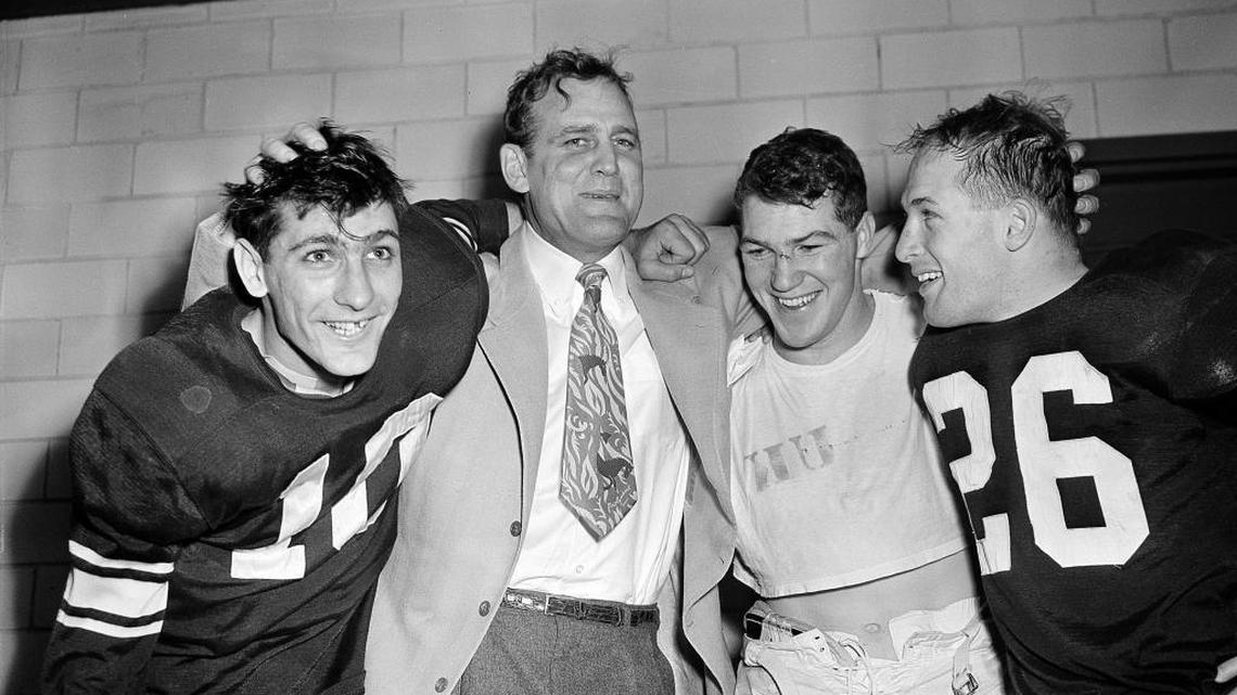 Kentucky Coach Bear Bryant, in tie, celebrated UK’s win over TCU in the 1952 Cotton Bowl with quarterback Babe Parilli, left, running back Ed Hamilton and end Emero Clark. Hamilton ran for a touchdown and Parilli threw two TDs to Clark in UK’s 20-7 win.