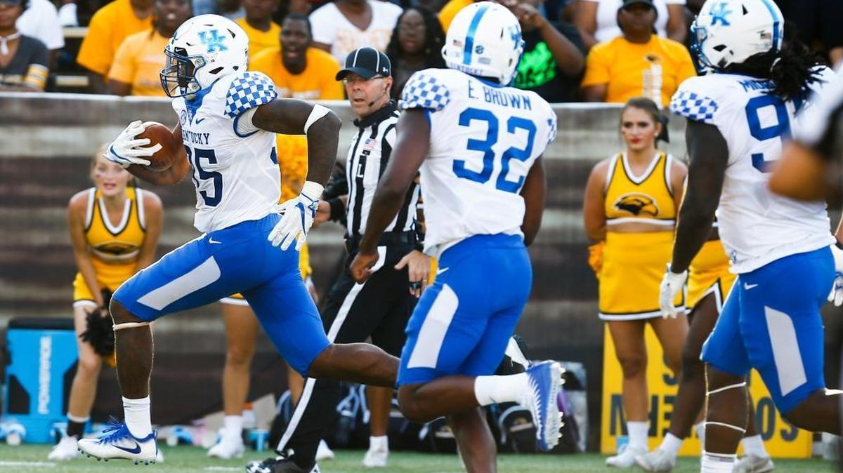 Kentucky defensive end Denzil Ware, with ball, ran 20 yards for a scoop-and-score touchdown to help UK open its season with a 24-17 win at Southern Mississippi last week.