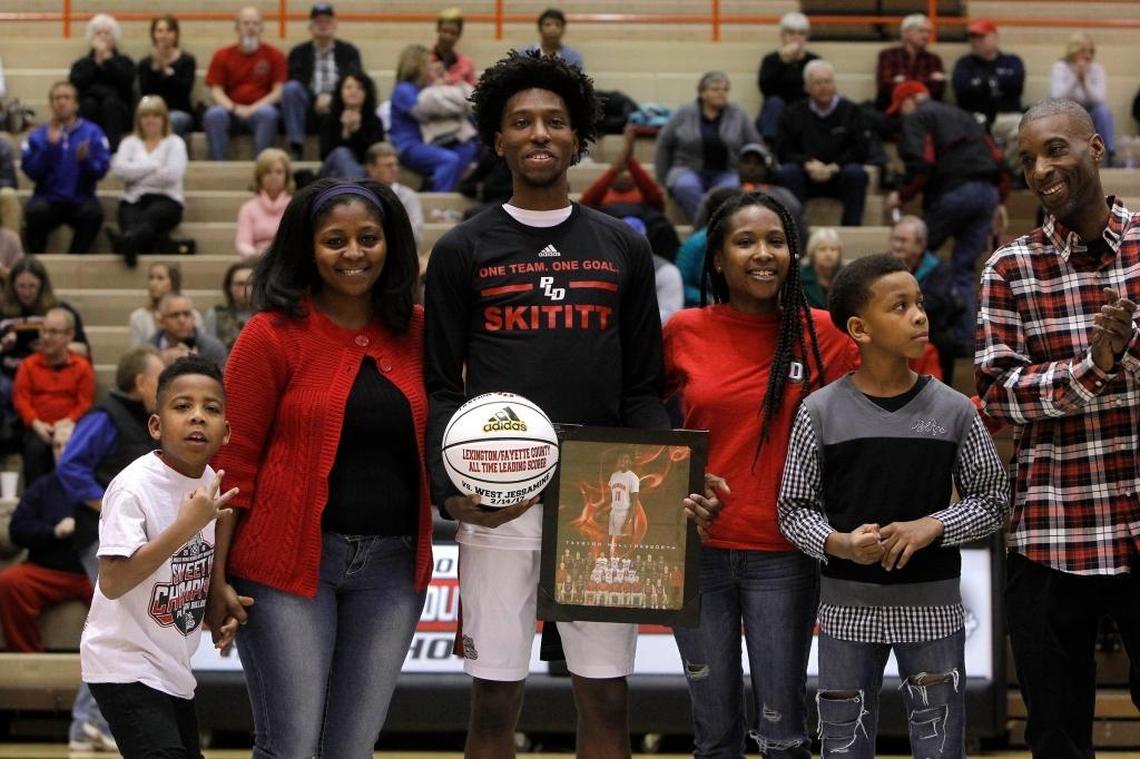 Taveion Hollingsworth surrounded by family at Paul Laurence Dunbar’s 2017 boys’ basketball Senior Night last Feb. 27.