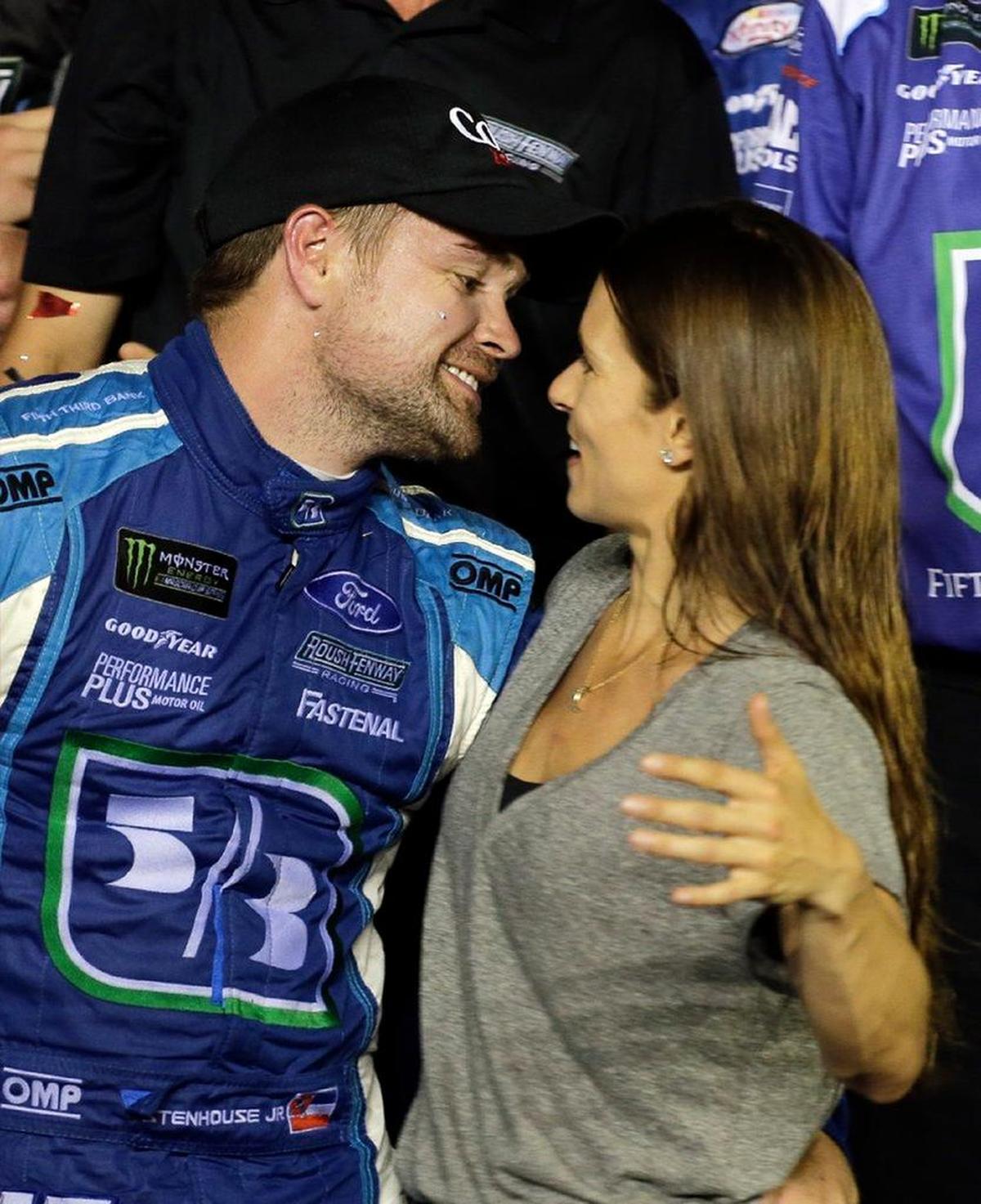 Danica Patrick, right, kissed boyfriend Ricky Stenhouse Jr. in victory circle at Daytona International Speedway Saturday night after Stenhouse Jr. won the Coca Zero 400. Patrick finished 25th in the race after getting collected in a late crash.