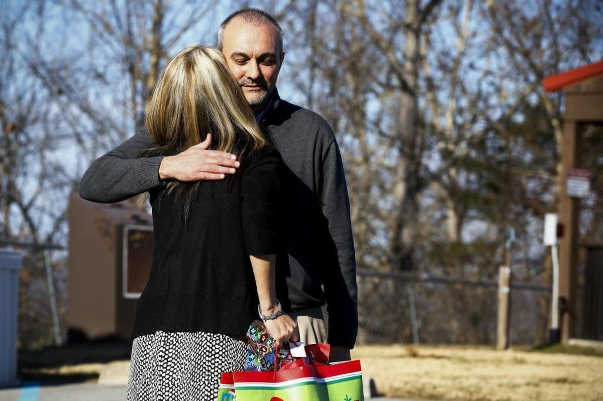 Former University of Kentucky basketball player Jody Thompson hugged Samantha Cook of Elkhorn City as he gave her a Christmas gift at Bob Amos Park in Pikeville this month. When in his early 30s, Thompson was diagnosed with polycystic kidney disease, a hereditary ailment that can cause kidney failure. After his condition became serious late last year, he received a kidney transplant from Cook this past summer.