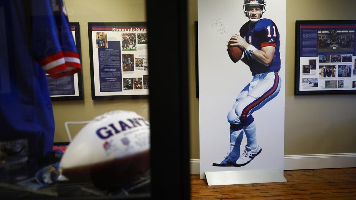 A life-size signed poster of Phil Simms sits with other memorabilia at the Phil Simms Exhibit located inside the Springfield Opera House in Springfield.