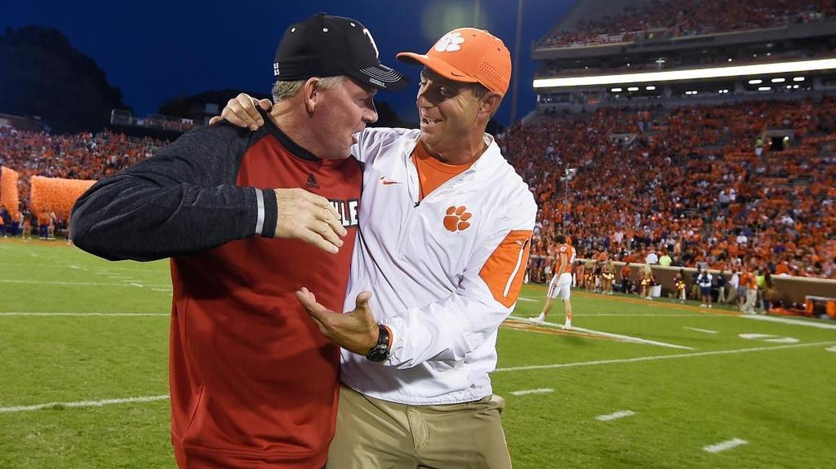 Louisville Coach Bobby Petrino, left, and Clemson Coach Dabo Swinney met before last year’s meeting between the Cardinals and the host Tigers, won by Clemson 42-36. On Saturday night, Clemson’s defending national champions will be in Louisville to face reigning Heisman Trophy winner Lamar Jackson and U of L.