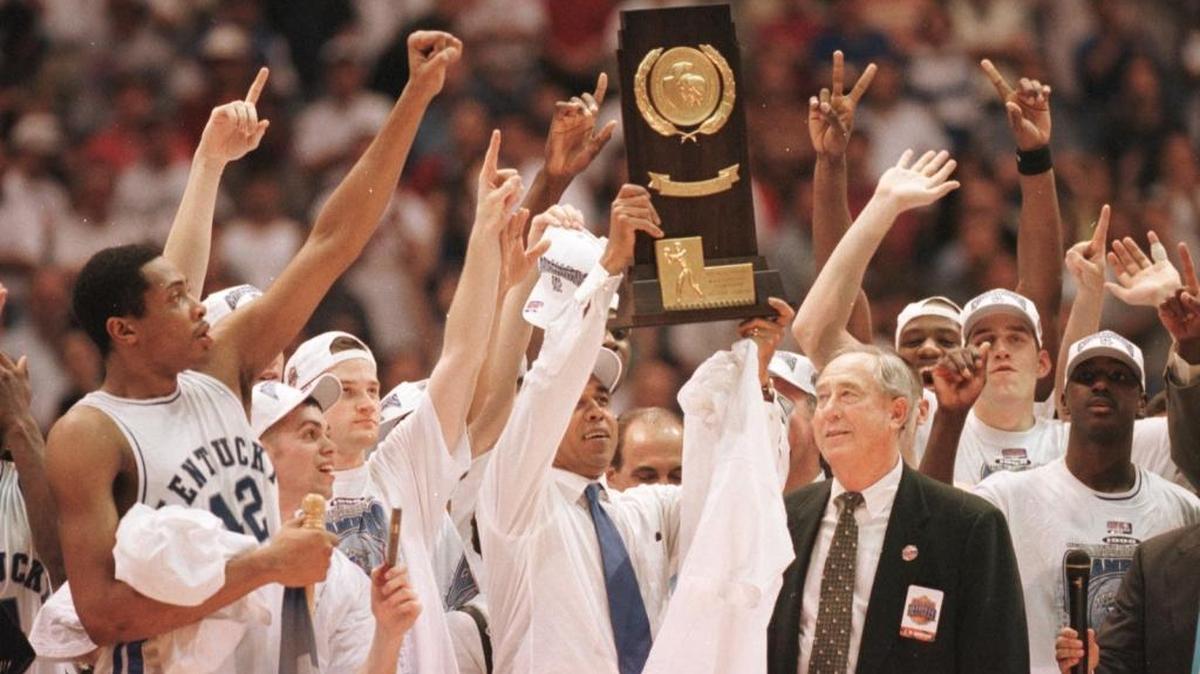 Then-Kentucky Coach Tubby Smith and the 1998 Wildcats hoisted the NCAA championship trophy after rallying from 41-31 down at halftime to beat Utah 78-69 and claim the most unlikely of UK’s eight men’s basketball national championships.