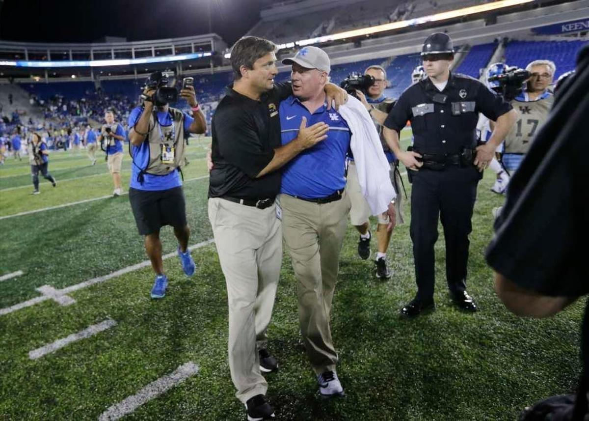 Southern Mississippi offensive coordinator Shannon Dawson, left, walked off the field with Kentucky Coach Mark Stoops after the Golden Eagles rallied from a 35-10 deficit to beat UK 44-35 in the 2016 season opener. Stoops had fired Dawson as UK offensive coordinator after the 2015 season.