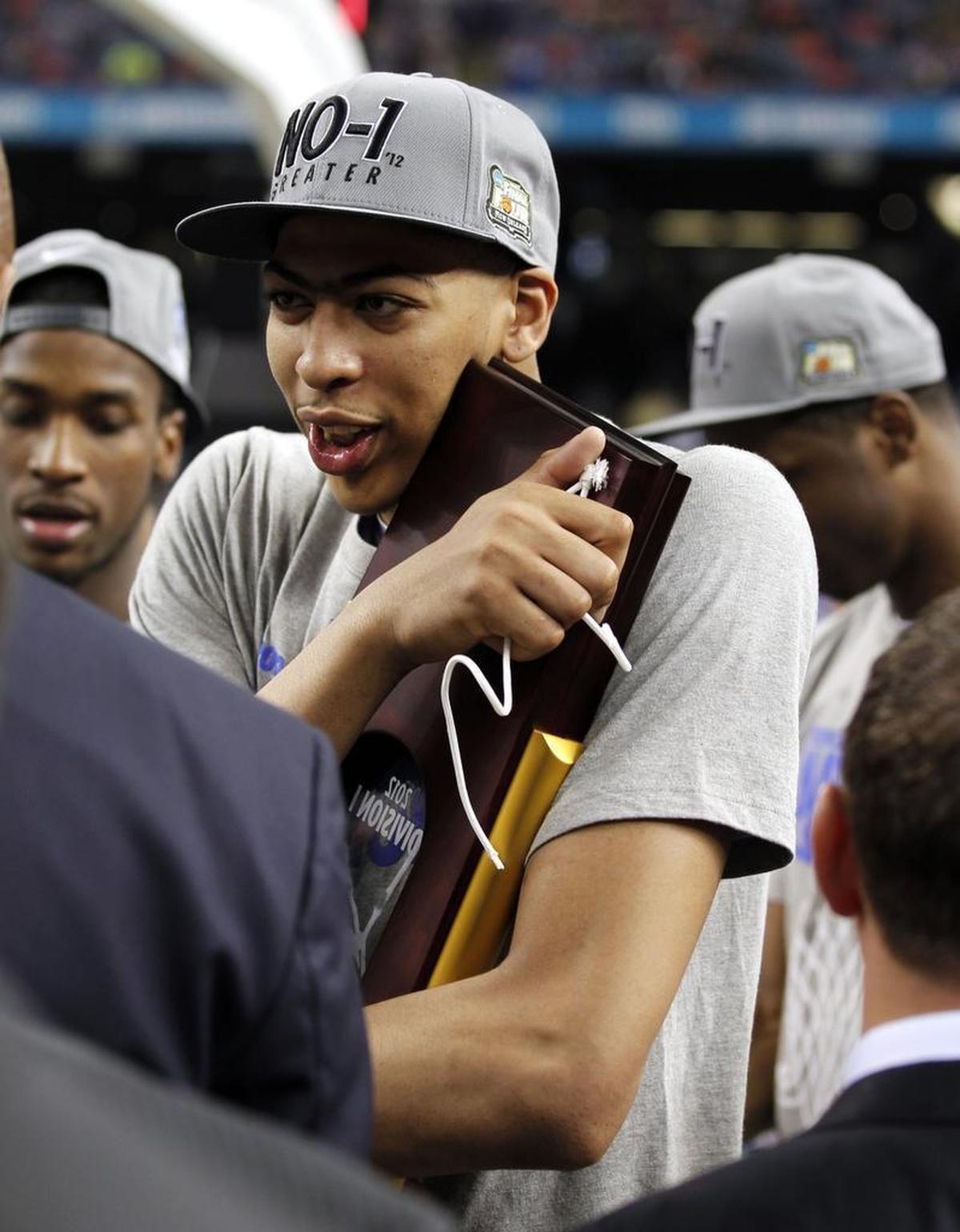 Kentucky star Anthony Davis hugged the NCAA championship trophy after the Wildcats beat Kansas to claim the 2012 national title in New Orleans.