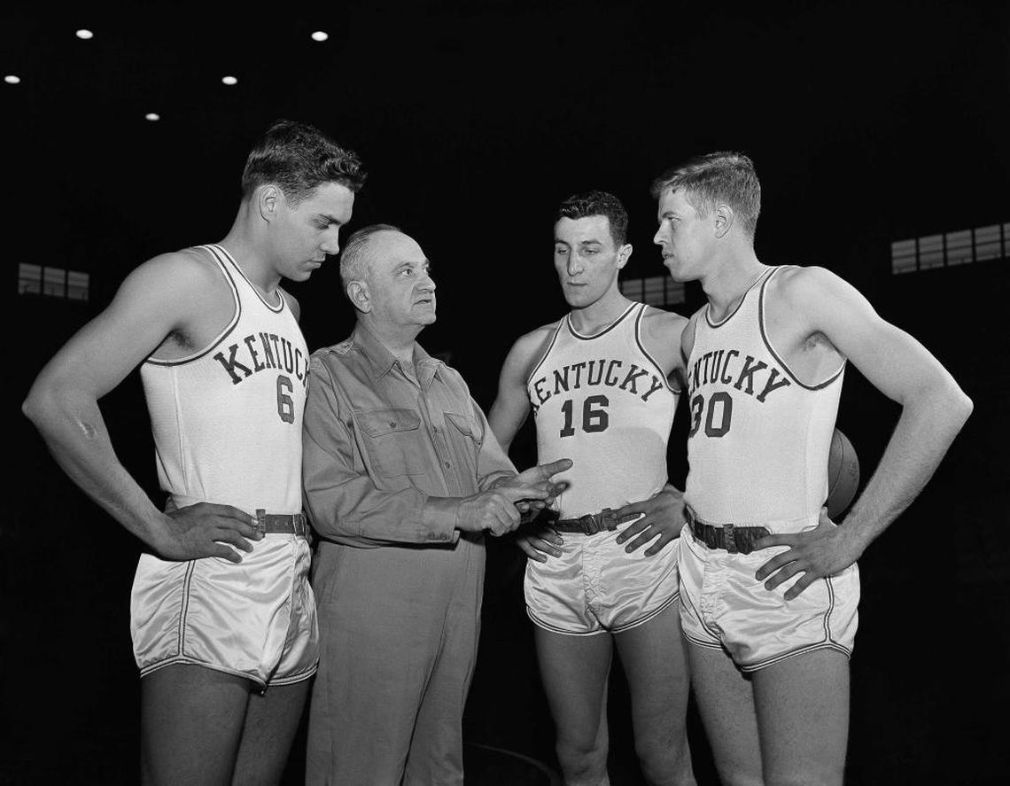 Coach Adolph Rupp, shown here with Cliff Hagan, left, and fellow UK stars Lou Tsioropoulos (16) and Frank Ramsey (30), won half of UK’s eight national titles.