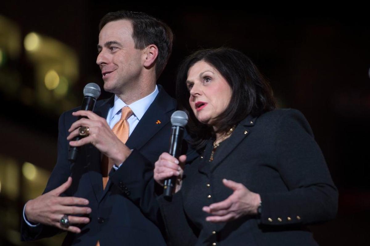 University of Tennessee Athletics Director John Currie and UT Chancellor Beverly Davenport spoke on stage during a ceremony introducing Currie in Thompson-Boling Arena in Knoxville, Tenn., in March. Davenport placed Currie on paid leave Friday amidst a football coaching search that had become polarizing.