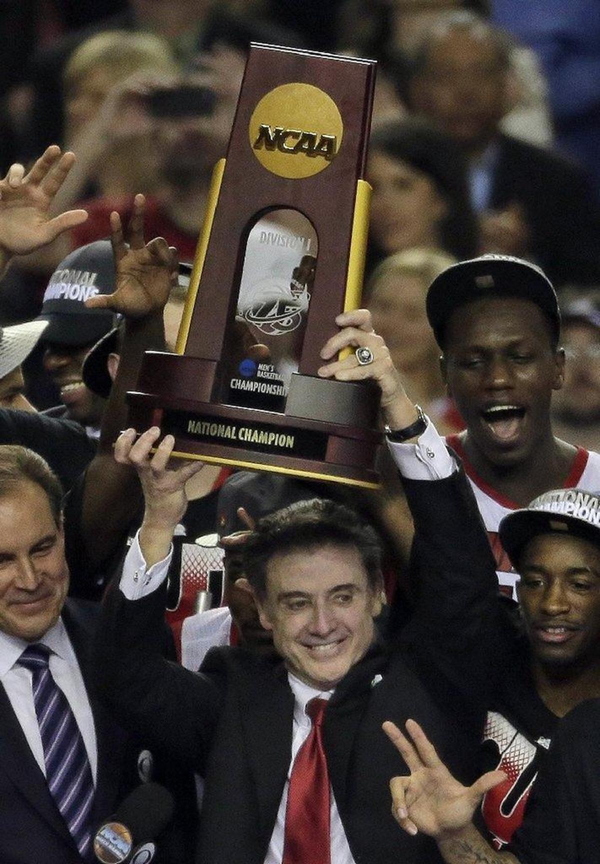 Rick Pitino held the championship trophy after Louisville beat Michigan to win the 2013 NCAA men’s basketball tournament. As a result of NCAA violations resulting from U of L’s “escorts and stippers for recruits” scandal, it is possible Louisville’s 2013 men’s hoops title could be the first ever vacated by the NCAA.