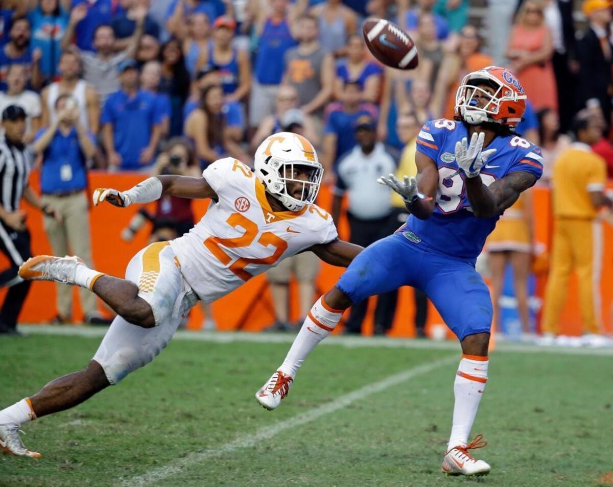 Florida wide receiver Tyrie Cleveland, right, hauled in the game-winning, 63-yard touchdown pass in front of Tennessee defensive back Micah Abernathy as time expired in the Gators’ 26-20 win last Saturday.