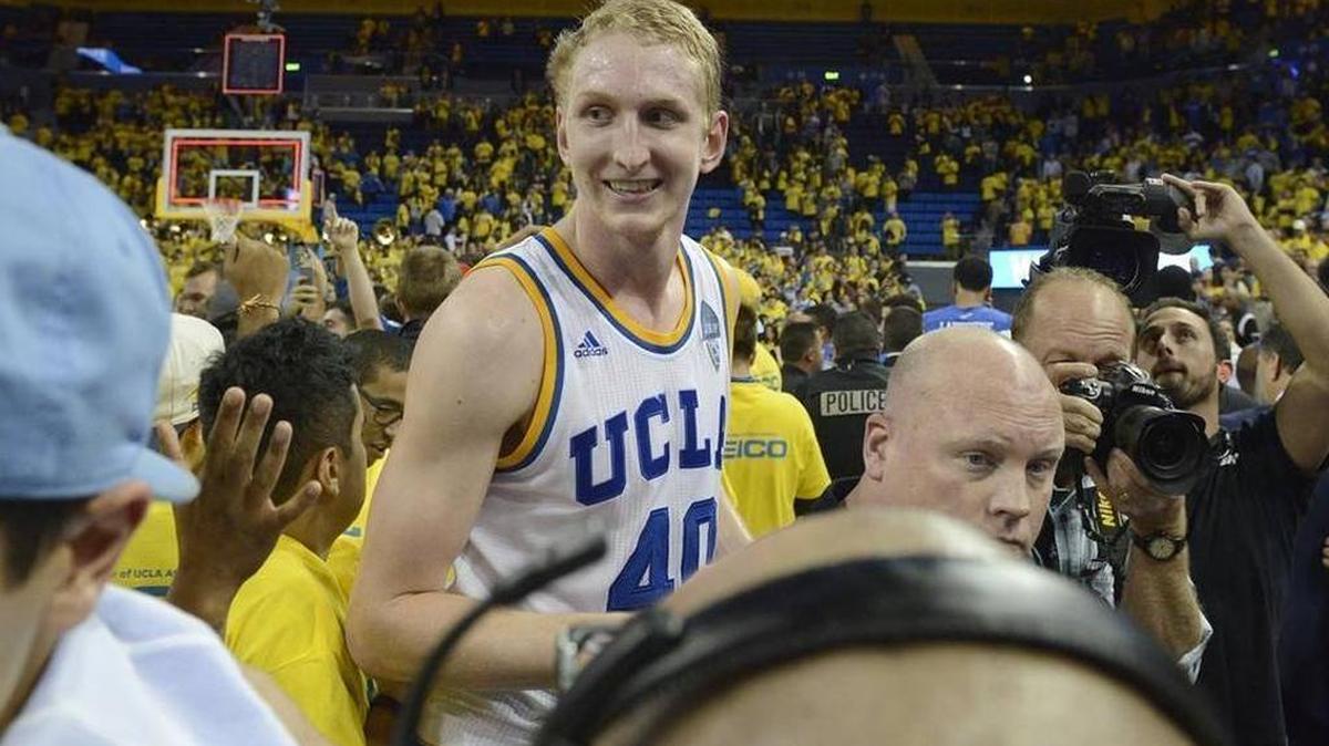 UCLA center Thomas Welsh, center, celebrates with fans after an NCAA college basketball game against Kentucky in Los Angeles, Thursday, Dec. 3, 2015. UCLA won 87-77.
