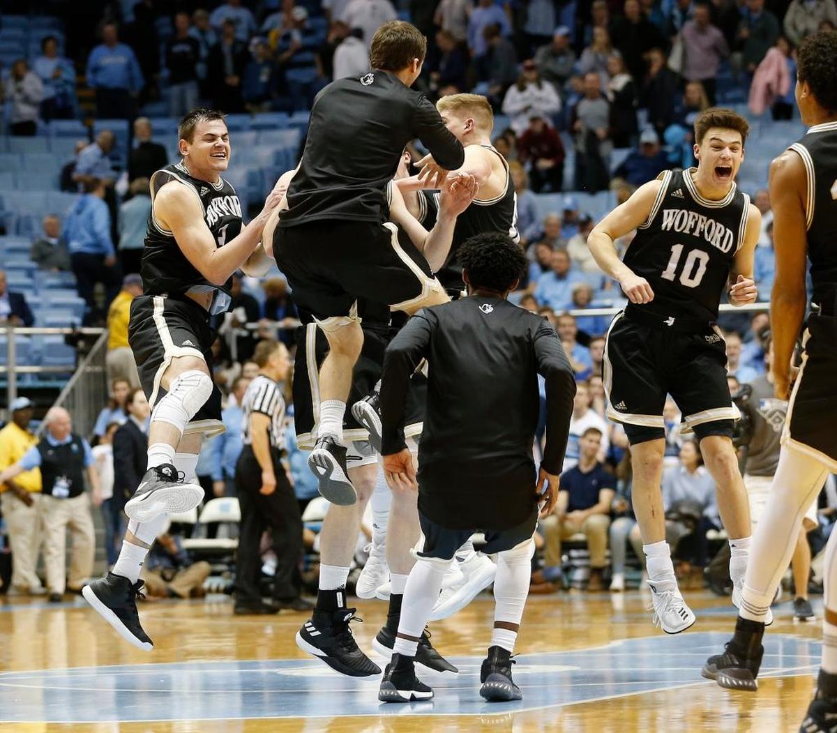 Wofford players, including Fletcher Magee, far left, celebrated after upsetting fifth-ranked North Carolina 79-75 last season at Chapel Hill.