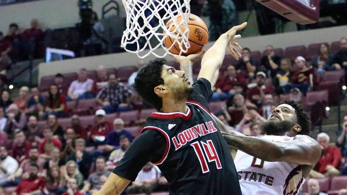 Florida State’s Phil Cofer tries to shoot around the defense of Louisville;s Anas Mahmoud in the first half of an NCAA college basketball game, Wednesday, Jan. 10, 2018, in Tallahassee, Fla. Louisville rallied from a 17-point deficit to beat the Seminoles 73-69.