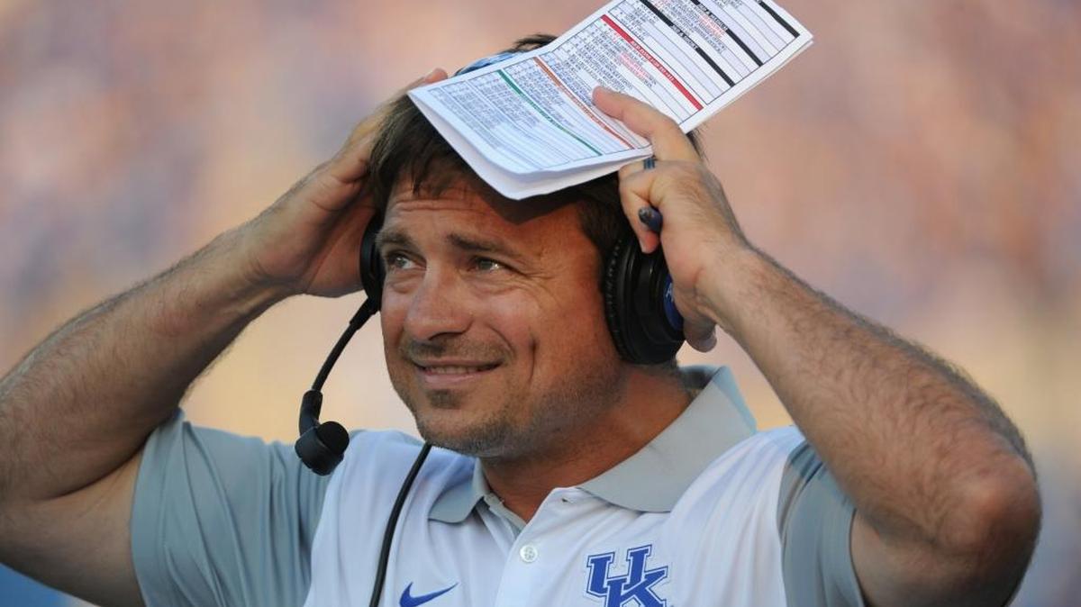 New offensive coordinator Shannon Dawson watches the celebration after the opening touchdown on the first play from scrimmage during the University of Kentucky-Louisiana-Lafayette football game in the newly renovated Commonwealth Stadium on Saturday 5, 2015.