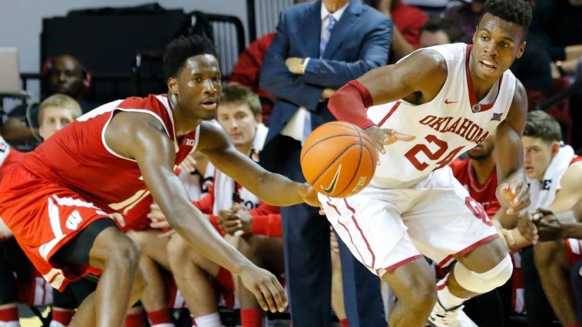 Wisconsin forward Nigel Hayes, left, and Oklahoma guard Buddy Hield, right, go after the ball during the second half of an NCAA college basketball game in Norman, Okla., Sunday, Nov. 29, 2015. Oklahoma won 65-48.