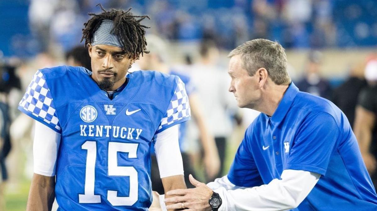 Kentucky athletics director Mitch Barnhart, right, offers encouragement to quarterback Stephen Johnson after UK’s last-second 37-34 loss to Ole Miss at Kroger Field on Saturday Nov. 4, 2017 in Lexington, Ky.