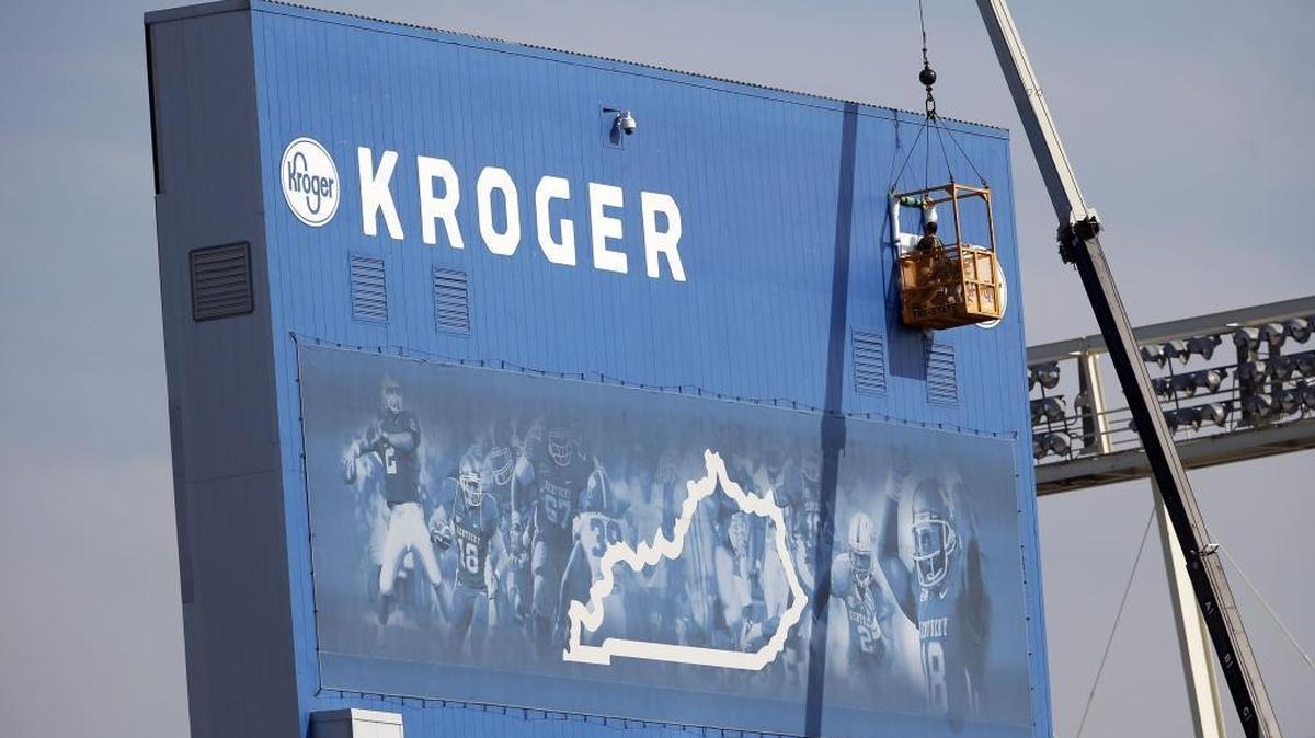 Workers placed the letters for Kroger Field on the scoreboard at the University of Kentucky’s stadium on Alumni Dr. in Lexington, Ky., Tuesday, August 22, 2017. Commonwealth Stadium is now known as Kroger Field, per a deal struck between the university, the UK athletics department and marketing partner JMI Sports.