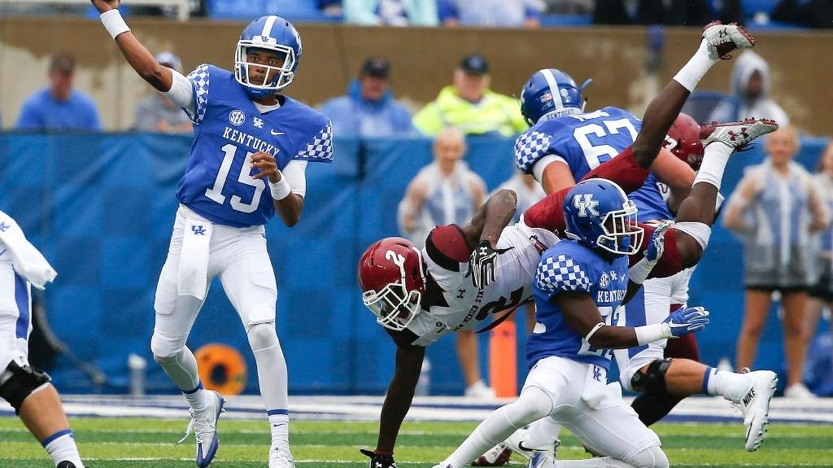 Kentucky running back Sihiem King (22) put a strong block on New Mexico State linebacker Terrill Hanks (2) as UK quarterback Stephen Johnson released a pass last Saturday at Commonwealth Stadium in Lexington, Ky.