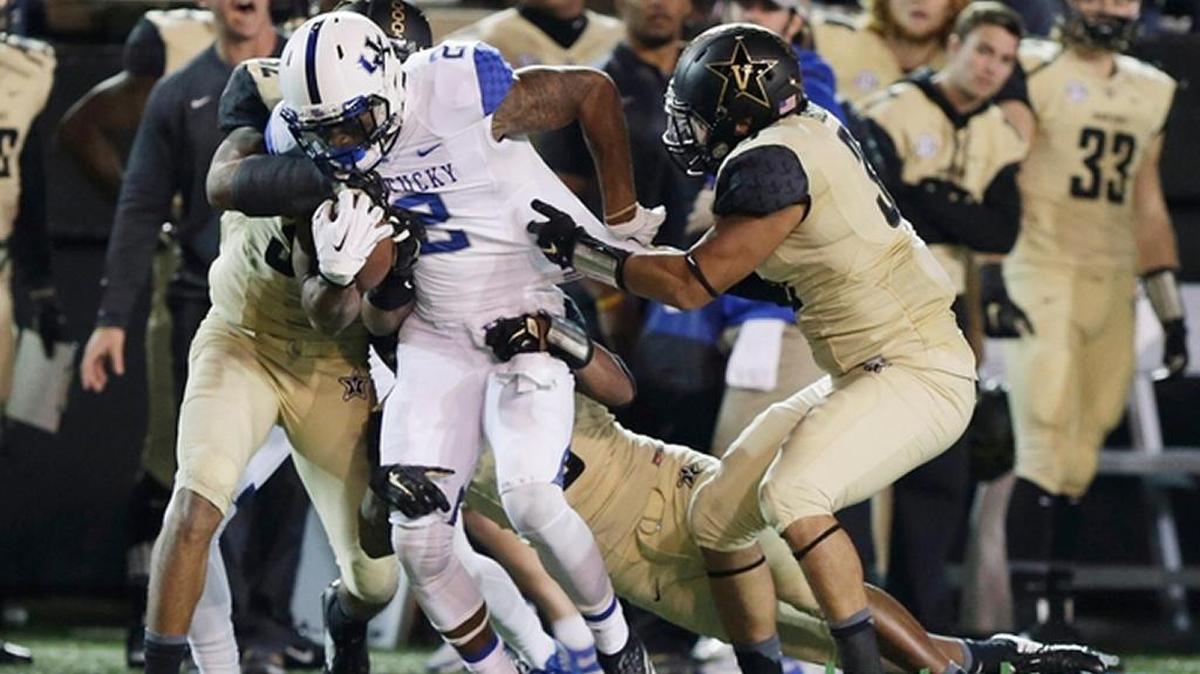 Kentucky receiver Dorian Baker makes a catch and struggles for yardage during UK’s 21-17 loss at Vanderbilt on Friday night.