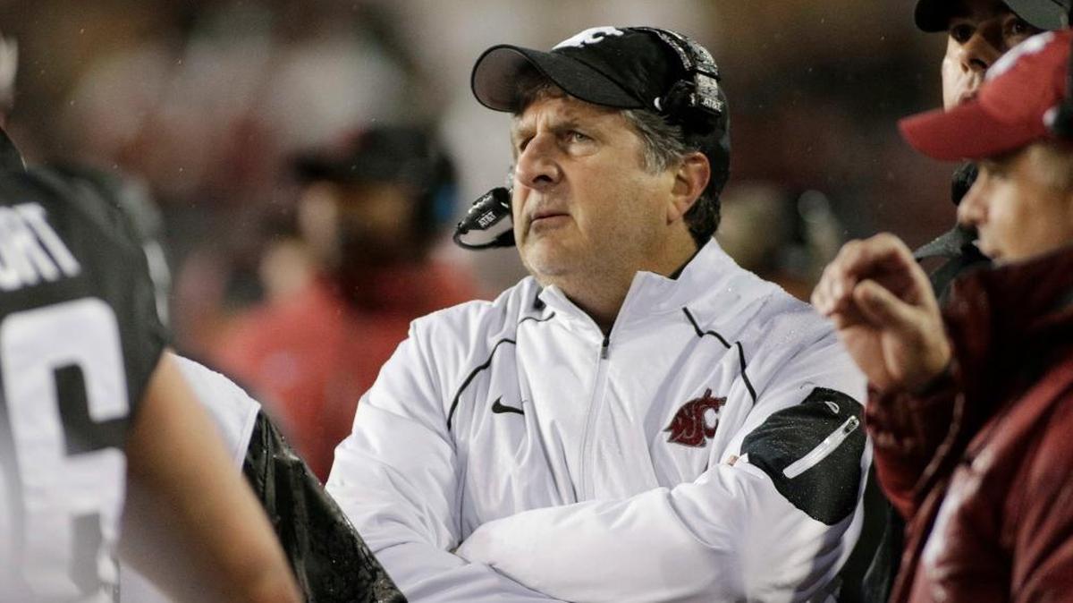 In this Oct. 21, 2017, file photo, Washington State coach Mike Leach watches from the sideline during the second half of the team's NCAA college football game against Colorado in Pullman, Wash. A person with direct knowledge of the meeting says Leach met with Tennessee athletic director John Currie to discuss the school’s coaching vacancy. The person spoke to The Associated Press on condition of anonymity because neither side intended to make the meeting public.
