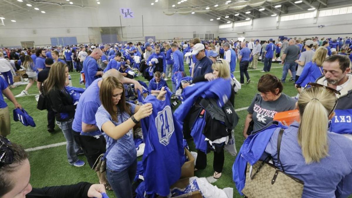 Fans dug through boxes of jerseys during the UK equipment sale at Nutter Field House in Lexington, Ky, on April 16, 2016. The sale opened early to season ticket holders.