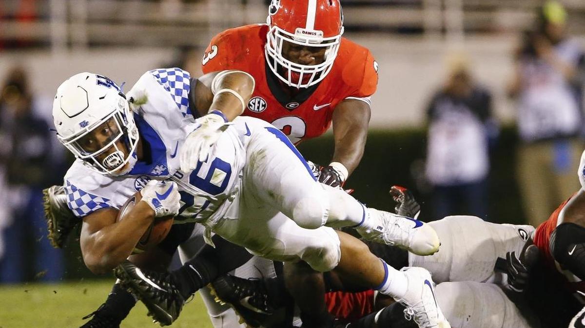 Kentucky running back Benny Snell Jr. (26) is brought down by Georgia linebacker Roquan Smith (3) during UK’s 42-13 loss to the Bulldogs at Sanford Stadium in Athens, Ga., Saturday, Nov. 18, 2017.