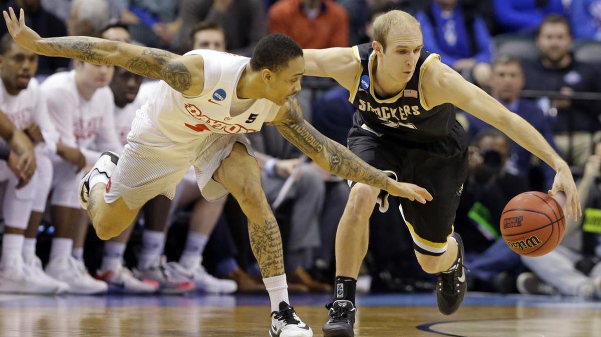 Wichita State guard Conner Frankamp (33) and Dayton guard Kyle Davis (3) go for a loose ball during the second half of Wichita State’s 64-58 win in the men’s NCAA college basketball tournament in Indianapolis, Friday, March 17, 2017.