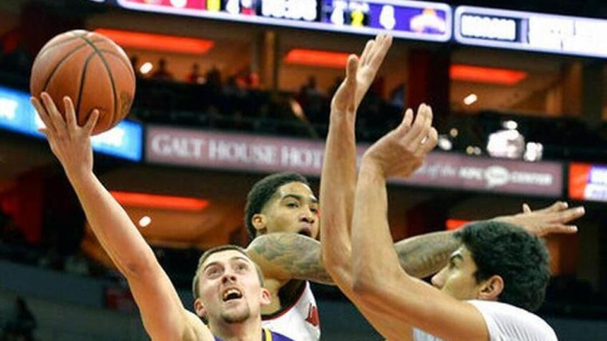 Louisville’s Anas Mahmoud (14) and Ray Spalding defend Albany’s Joe Cremo during the Cardinals’ 70-68 win at the KFC Yum Center in Louisville on Dec. 20, 2017. Louisville is blocking 8.4 shots per game.