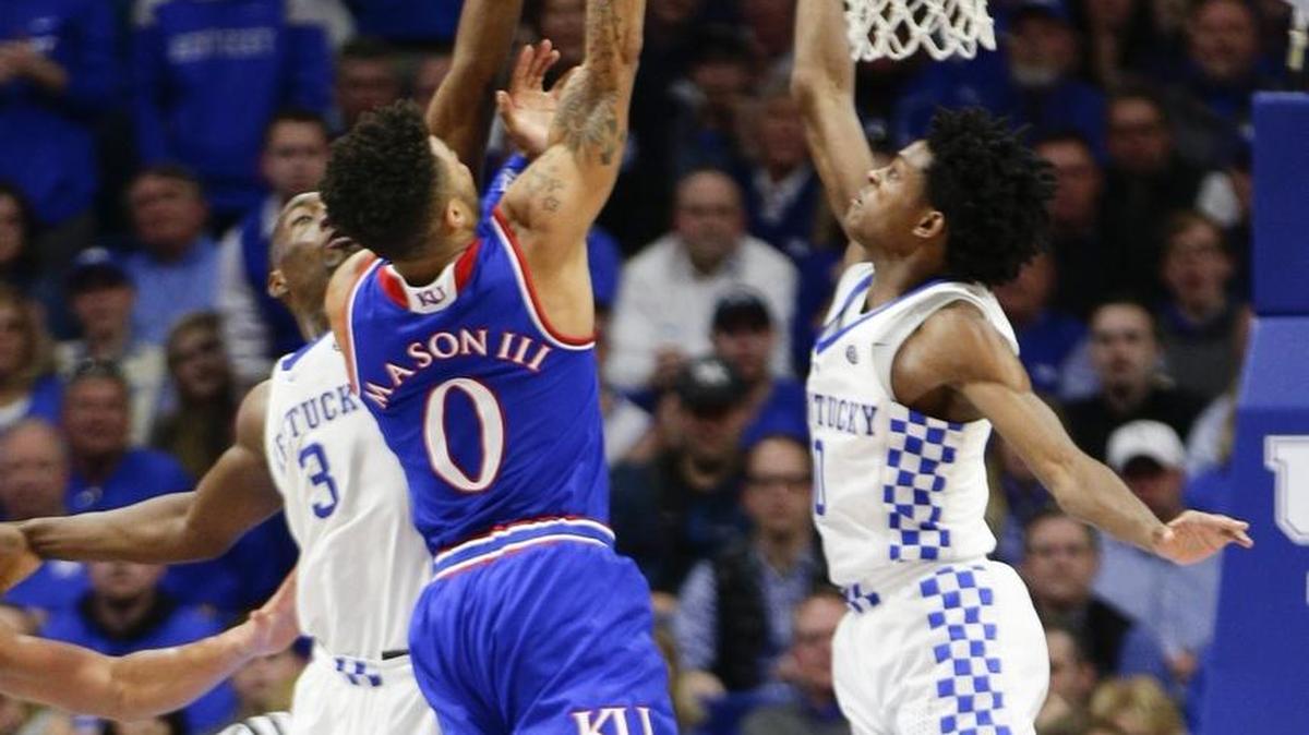 Kansas guard Frank Mason III (0) scores two of his 21 points as Kansas defeated Kentucky 79-73 in the SEC/Big 12 Challenge on Saturday, November 28, 2017 in Lexington, Ky.