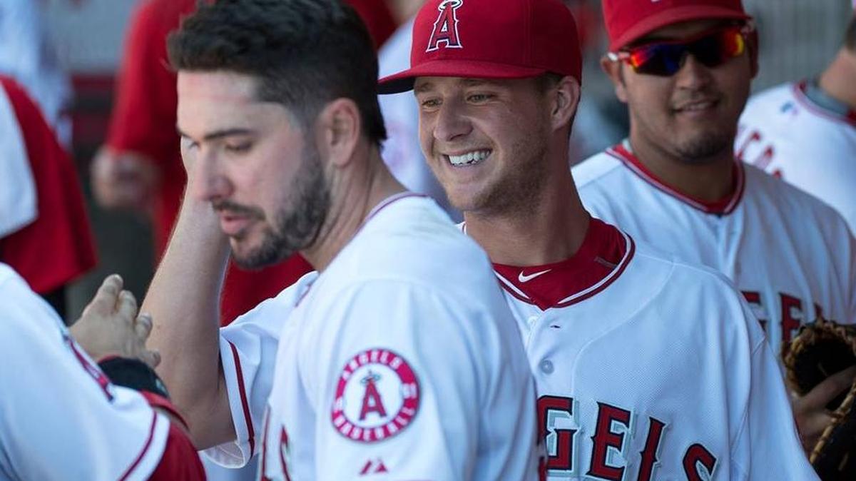 Los Angeles Angels bench greets Trevor Gott, center, after he pitched during a baseball game against the Oakland Athletics, Sunday, June 14, 2015, in Anaheim, Calif.