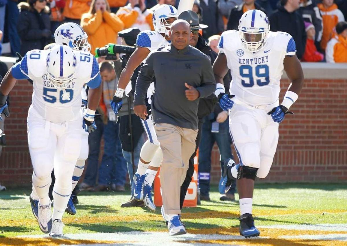By several metrics, Kentucky defenses were better during the ill-fated, three-year head coaching tenure of Joker Phillips, middle, than they have been in the five years since UK hired ex-Florida State defensive coordinator Mark Stoops as its head coach.